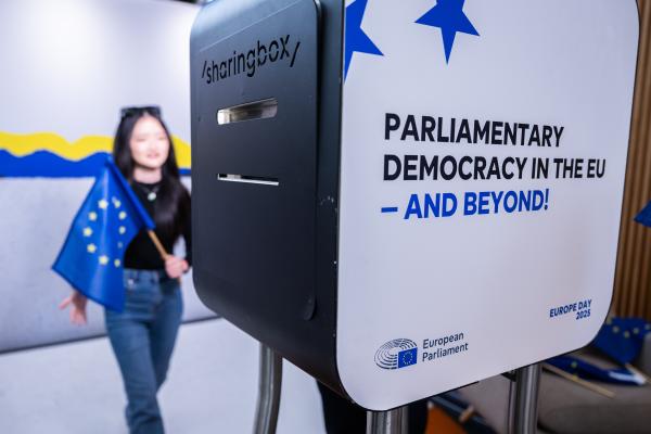 Young woman with European flag being photographed